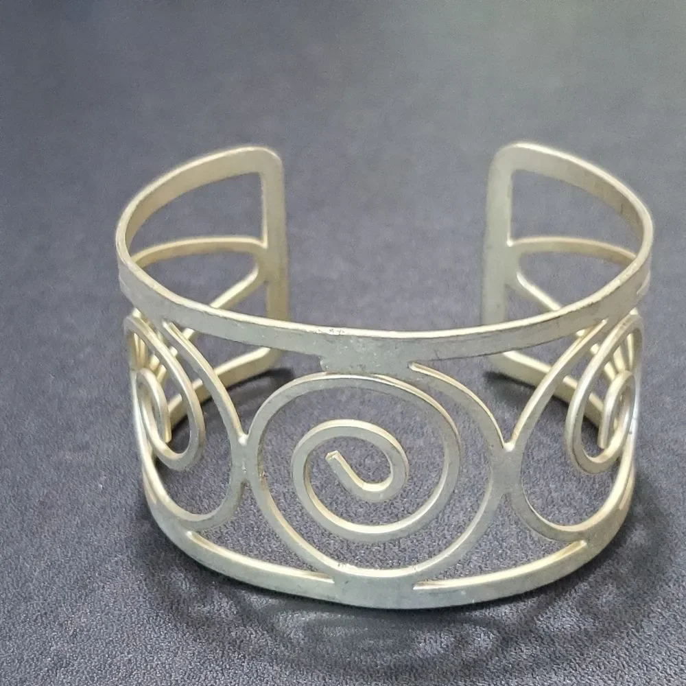 Gold tone swirly bangle cuff bracelet